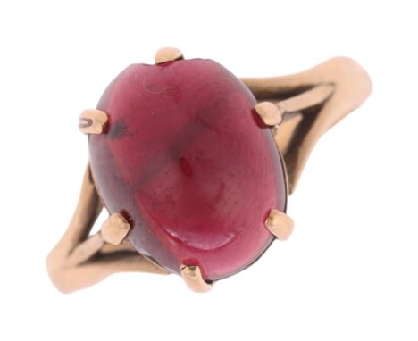 A 9ct gold garnet dress ring, claw set with oval cabochon garnet, setting height 10.8mm, size N, 3.3g . Condition Report:Garn