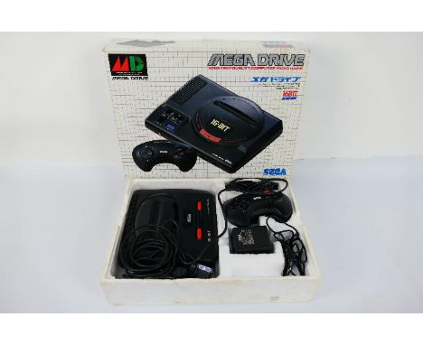 Sega - Mega Drive II. A Sega Mega Drive 2 with 2 controllers, Scart cable, Power Supply (working) Instructions and Sonic The 