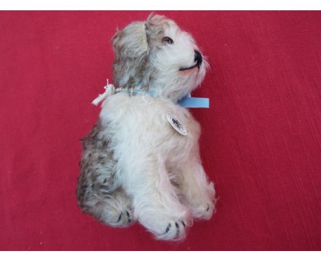 Steiff - Molly 1925 Replica Dog, seated, brown and white mohair, pale blue ribbon to the neck, issued in a limited edition of