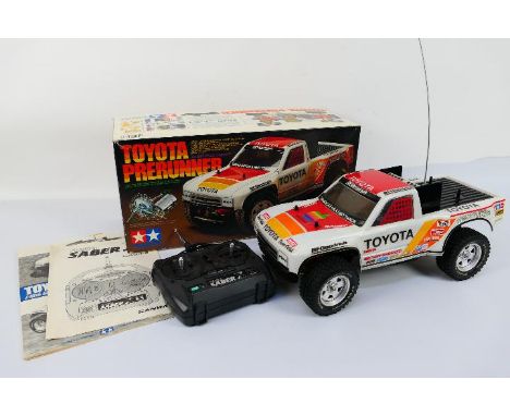 Tamiya - A boxed Tamiya 1/10 scale Toyota Prerunner radio controlled racing truck in fully assembled and only very lightly us