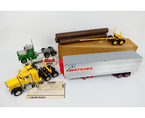 AMT - 2 x built kit model trucks and trailers in 1:25 scale, a Peterbilt 359 tractor unit # T501 with Peerless log trailer # 