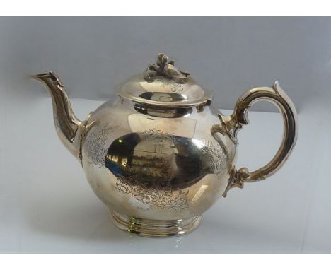 A Victorian silver teapot, R & S Garrard & Co., London, 1850, the plain globular body flat-chased with flower bunches and mon