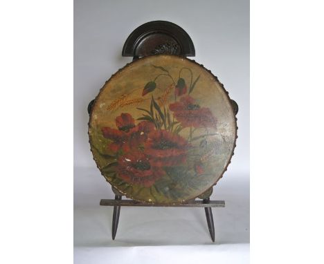 A 19th century timber framed tambourine, the hide decorated with a hand painted study in oil of poppies amongst barley, signe