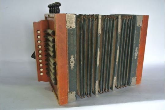 A vintage German thirteen button accordion with bellows marked Ludwig ...