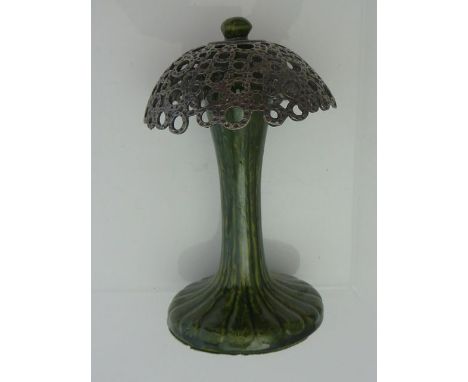 An unusual decorative stand of mushroom form, the mottled green ceramic base with moulded detail set above a pierced white me