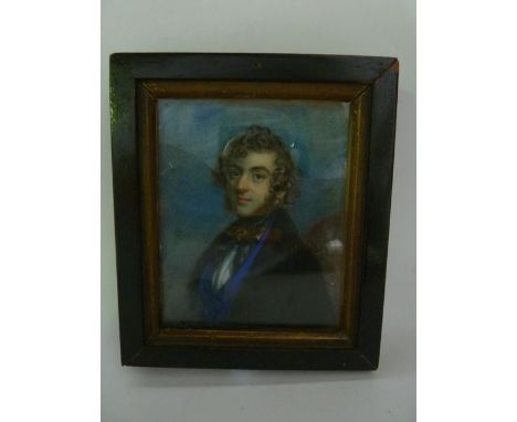 A mid 19th century portrait miniature on ivory - young man with curly hair and sideburns