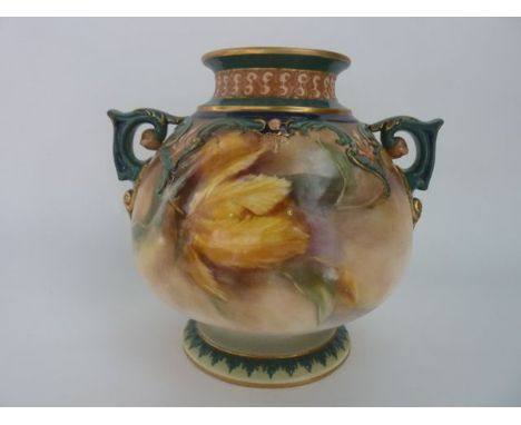 A 19th century Hadley's Worcester two handled vase with painted yellow floral decoration beneath a green gilt and peach mould