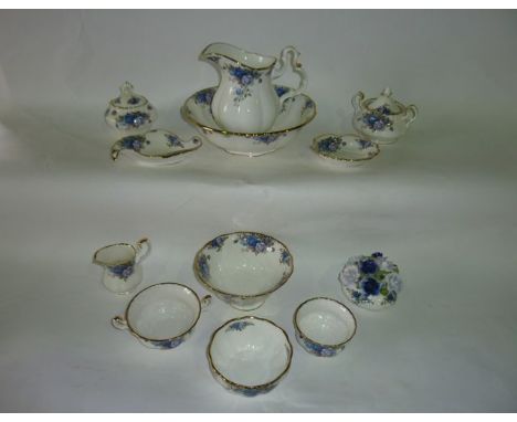 A collection of Royal Albert Moonlight Rose pattern wares comprising a ewer and basin, a posy vase containing blue roses, a t