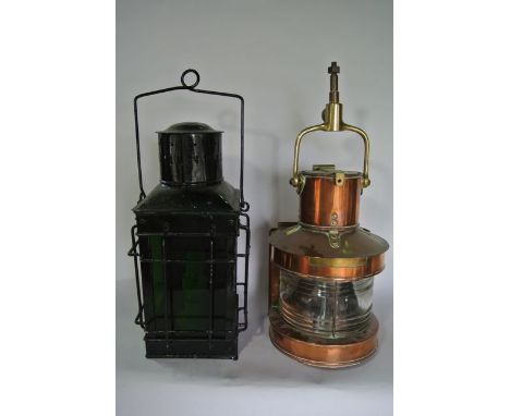 A marine mast head lamp in copper together with a painted tin storm lantern