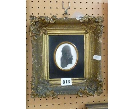 An 18th century silhouette portrait miniature showing a gentleman in profile, of oval form, 8 cm maximum approx. in black mou