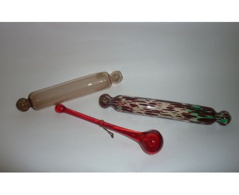 A Victorian glass rolling pin with clear ground decorated in mottled patches of burgundy, 37 cm long approx. together with a 