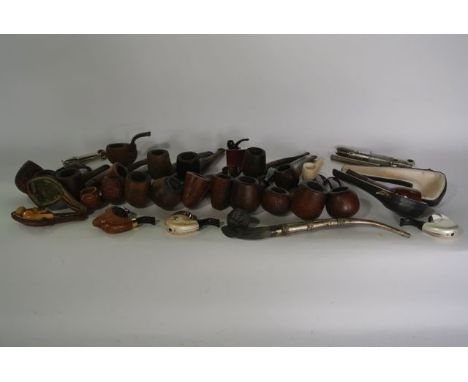 A box containing a quantity of vintage tobacco pipes to include a Meerschaum type example with carved dog finial, etc