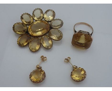 A brooch, of flower head form, set with ten oval mixed-cut gemstones, possibly citrine, in an unmarked gold frame; a dress ri