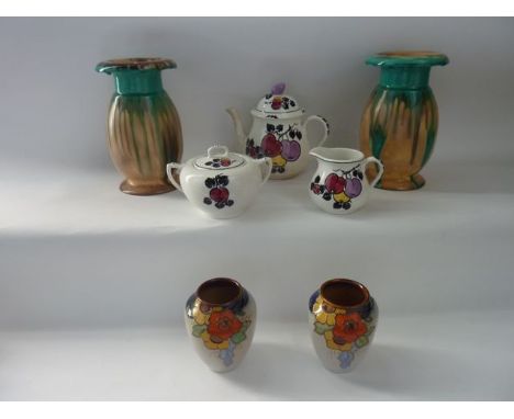 A collection of Art Deco ceramics including a pair of Royal Doulton vases with moulded and painted orange and yellow stylised