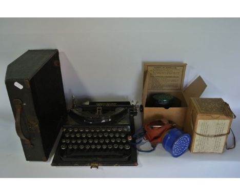 A vintage Smith Premier portable typewriter together with two Second World War gas masks in original cardboard boxes, one adu