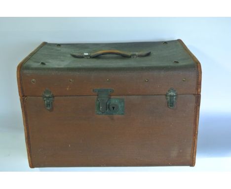 A vintage travelling case of rectangular form with stitched leather border and brass locking clasp and mounts bearing further