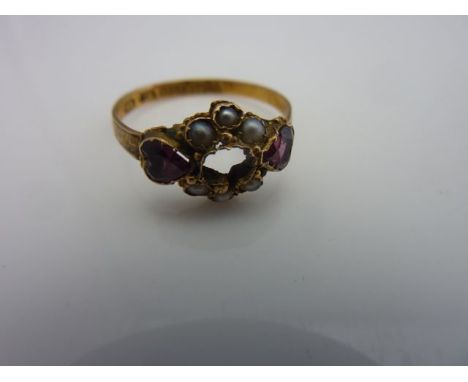 A Victorian ring, the central stone lacking, flanked to each shoulder with a heart-shaped almandine garnet, further embellish