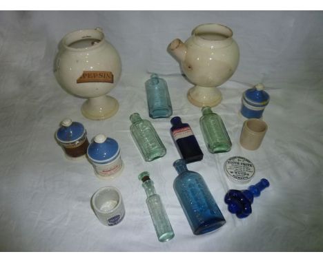 Two large 19th century ceramic chemist's wet drug jars, a selection of 19th century glass chemist's bottles, further ceramic 