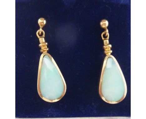 A pair of opal stud earrings, each drop-set with a teardrop shaped opal, in 9ct gold (2)