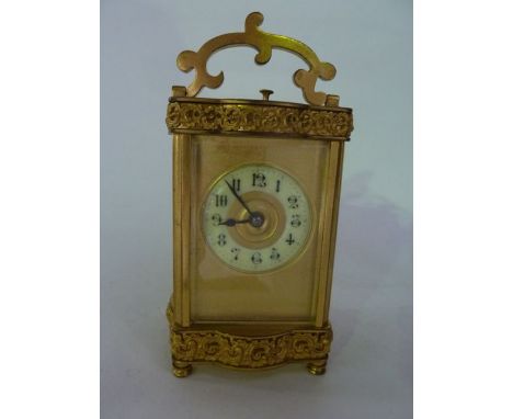 A 19th century brass carriage clock with foliated borders and 8-day striking movement, with original green casework