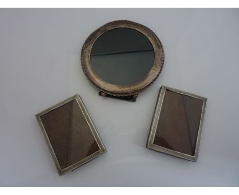 A pair of George V silver easel back photo frames, Sanders & Mackenzie, Birmingham, 1927, each rectangular frame with engine-