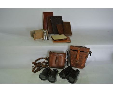 A vintage leather cased set of adjustable binoculars operating in marine, field and theatre mode together with a further pair
