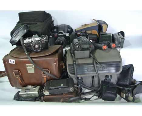 A quantity of vintage photographic equipment to include a cased Olympus OM10 camera with related effects, numerous lenses to 