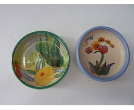 Two Clarice Cliff pin dishes of circular form, one with abstract style painted decoration incorporating a yellow flower with 