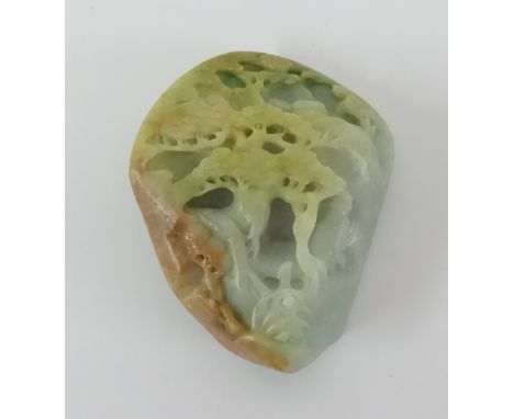 A Oriental jade carving depicting a figure in a tree landscape, height 12cm.