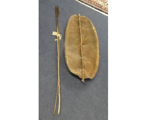 An old African shield and two hunting spears, height of shield 117cm.