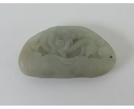 A Oriental small jade carving depicting dragons, length 6cm.