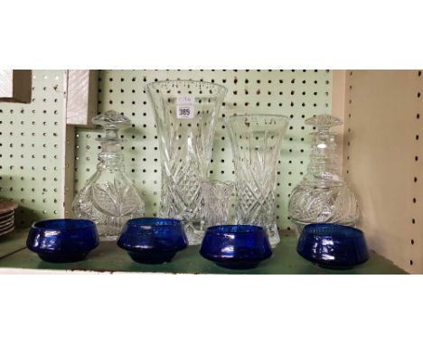 SHELF OF BLUE GLASSES WITH 2 DECANTERS & STOPPERS & VASES, 1 STOPPER BROKEN 