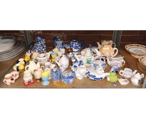 SHELF OF MISC TEA POTS & EGG CUPS