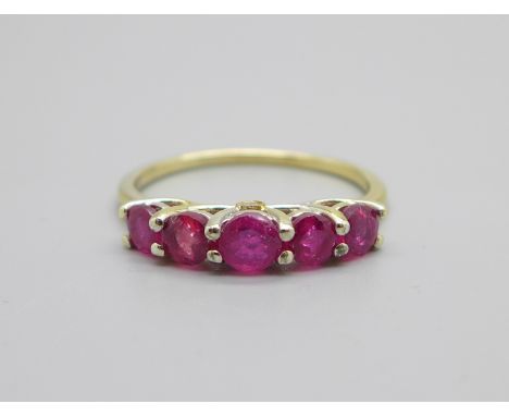 A silver gilt, five stone ruby ring also set with two small diamonds, Q 