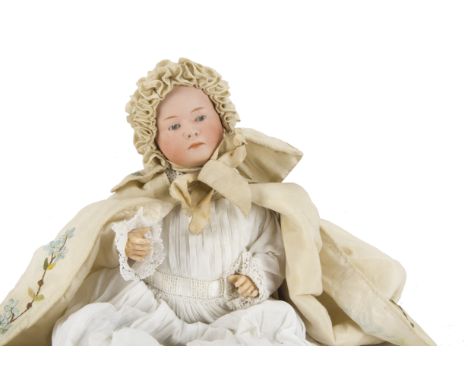 A Gebruder Heubach 7602 character baby, with blue intaglio eyes, closed down turned mouth, composition bent limbed body, cott