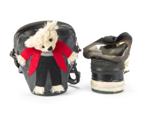 A rare and unusual British child’s gas mask teddy bear case, the black leather bag with shaggy mohair head, black boot button