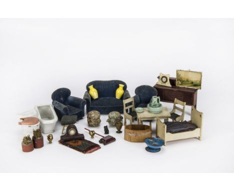 First quarter 20th century dolls’ house furniture: a blue velvet three piece suit, a German lead carpet sweeper, a pair of ye