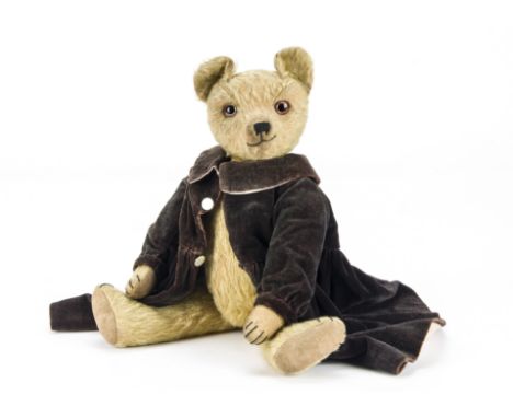 An Omega teddy bear 1920s, with golden mohair, clear and black oily glass eyes with brown painted backs, pronounced muzzle, b