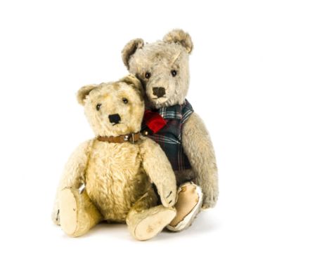 Two post-war Steiff teddy bears: one with light golden mohair, brown and black glass eyes, black stitched nose, mouth and cla