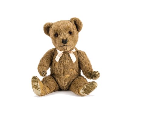 An unusual Chiltern Hugmee teddy bear 1950s, with rare light brown alpaca plush, orange and black glass eyes, black stitched 