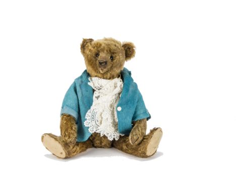 A Steiff cinnamon mohair teddy bear circa 1909, with black boot button eyes, pronounced muzzle, black stitched nose and claws