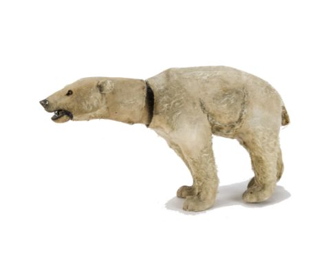 A rare German clockwork nodding polar bear 1920s, cardboard and composition covered in white mohair, orange and black glass e