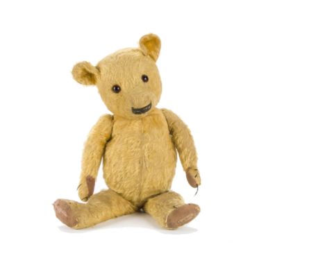 A Chad Valley Magna type teddy bear 1930s, with golden mohair, replaced orange and black glass eyes, pronounced muzzle, broad