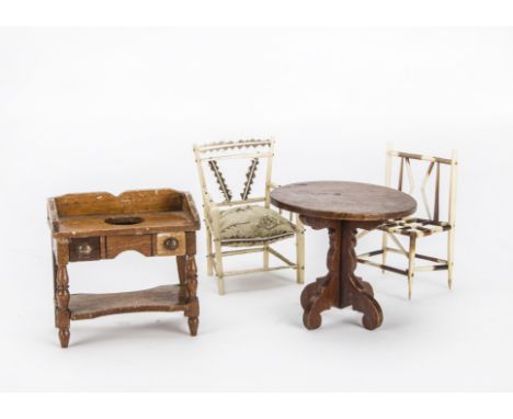 An early English dolls’ house washstand, varnished wood with two drawers and ink R/7 to back -4½in. (11cm.) wide (top right s