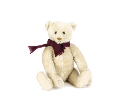 A fine 1920s Steiff white mohair teddy bear, with brown and black glass eyes, pronounced slightly clipped muzzle, brown stitc