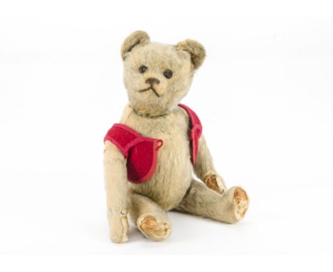 A 1930s Schuco yes/no teddy bear, with golden mohair, rare jeweled eyes, pronounced muzzle, black stitched nose and mouth, ta