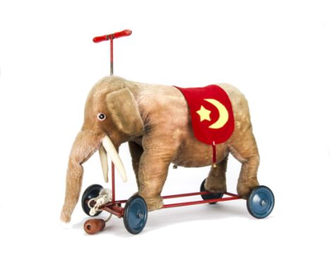 A Steiff 1930s ride on elephant on wheels, with grey mohair, replaced eyes, pull-cord growl, metal framed chassis with steel 
