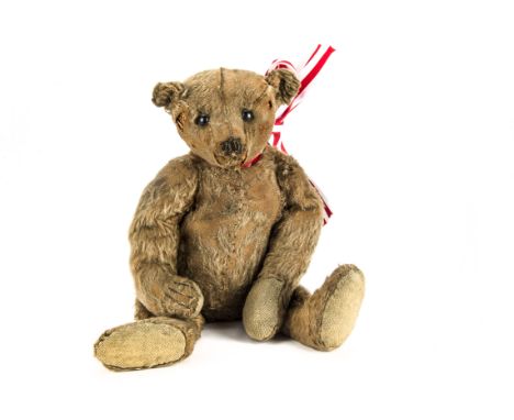 An early Steiff centre-seam teddy bear 1908, with cinnamon mohair, black boot button eyes, pronounced muzzle, remains of blac