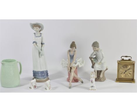 A Lladro porcelain figure of a seated boy together with two Nao figurines, a Swiza 8 day alarm clock, a mid 20th Century cera