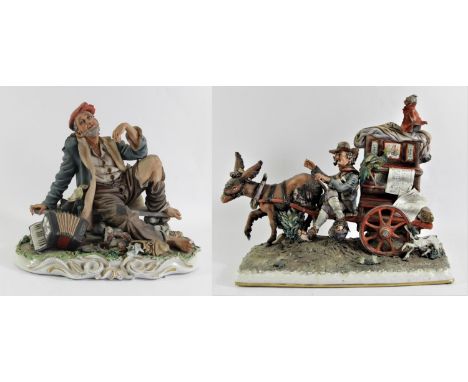 A Capodimonte bisque figurine of a street musician and his grinder, created by Scapinello, makers mark to base.H36cm, W44cm, 